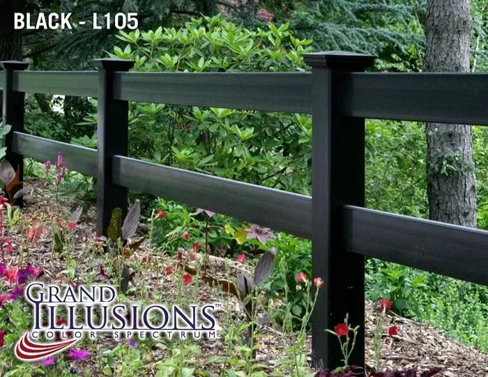 Black fence with three horizontal rails, surrounded by flowers and greenery.