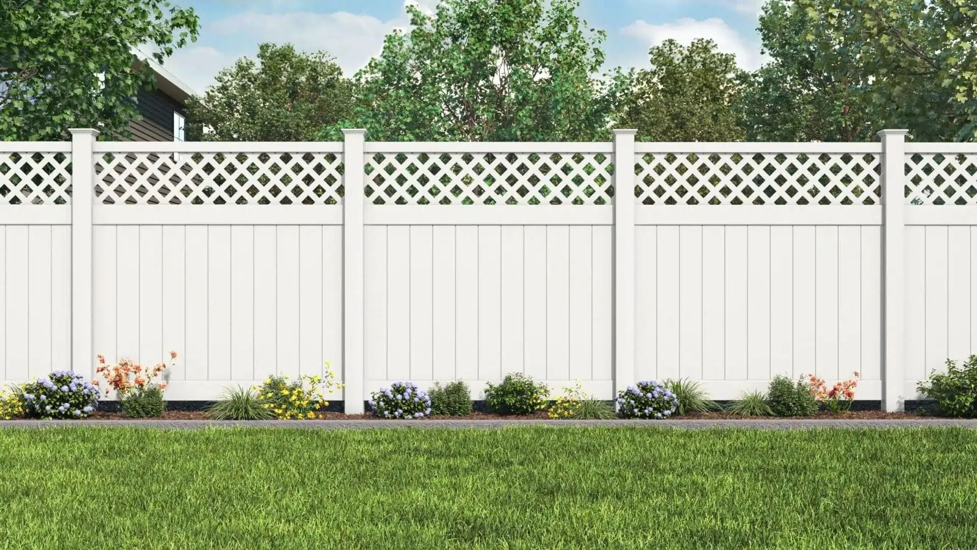 White picket fence with lattice top, green lawn, flowers, and trees.
